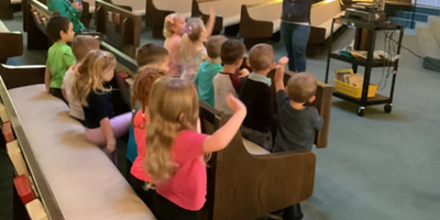 preschool children standing in sanctuary singing